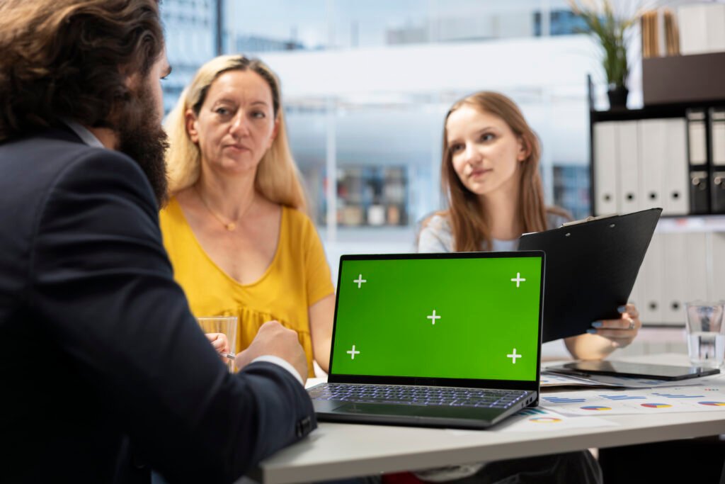 Clients checking investment plan on chroma key laptop